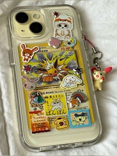 an iphone case with various stickers and magnets attached to the back of it