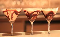 three martini glasses filled with liquid and chocolate