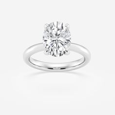 a round brilliant cut diamond ring on a white background