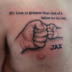 a man's chest with a tattoo saying, no love is greater than that of a father for his son