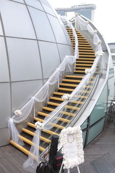 the stairs are decorated with white flowers and tulle, along with a sign that says 50