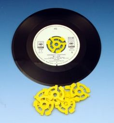 an old record and some yellow plastic discs on a blue background with the word love written in it