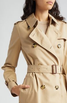 From Burberry's Heritage collection comes the latest iteration of the coat that made the brand: an iconic double-breasted trench cut from cotton gabardine. 42 1/2" length (size 8) Double-breasted button closure Notched lapels with hook-and-eye throat latch Belted cuffs Side button-welt pockets Epaulets Gun flap Back vent Lined with check-patterned fabric 100% cotton Dry clean Made in the UK Designer Clothing Burberry Trench Coat Outfit, Burberry Trench Coat Women, Rain Coats, Trench Coat Outfit, Cold Weather Outfit, Burberry Trench, Burberry Trench Coat, Double Breasted Trench Coat, Cold Weather Fashion