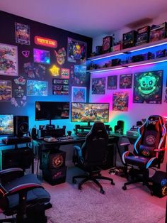 a room filled with lots of computer equipment and gaming monitors on the wall above them