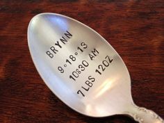 a close up of a spoon on a table with the date and time engraved on it