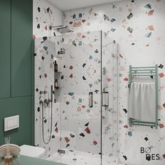 a bathroom with green walls and patterned wallpaper, including a glass enclosed shower stall