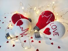 two crocheted mittens sitting next to each other on top of a table