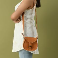 Jazz yourself up with this cross-body sling bag. The bag is made of full-grain leather, which gives it a minimal yet classy overall look. You can carry it to your office, college, or even a party to sweeten your look. Salient Features Material: full-grain leather Color: Tan brown Adjustable Shoulder Strap Minimal yet classy design High-quality brass hardware Handcrafted to ensure the utmost finishing. Eco-friendly and chemical-free tanning process. Sizes in Inches 9 W x 7 H x 2 D Inch 11 W x 9 H Cross Body Sling Bag, Canvas Leather Bag, Classy Design, Shop Light, Canvas Bags, Chemical Free, Online Bags, Brass Hardware, 7 H