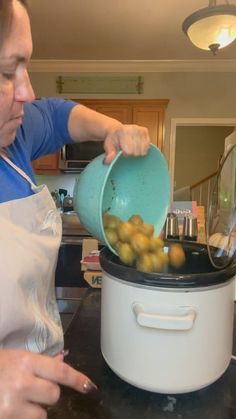 a woman pouring olives into an electric pressure cooker