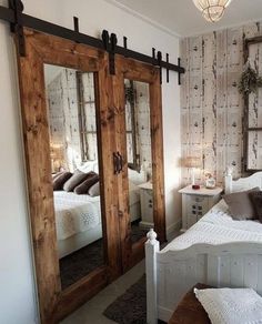 a bedroom with mirrored doors and white bedding