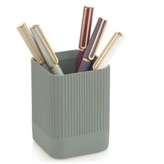 a pen holder with four pens in it