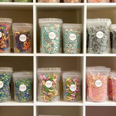 the shelves are filled with many different types of candies and sprinkles