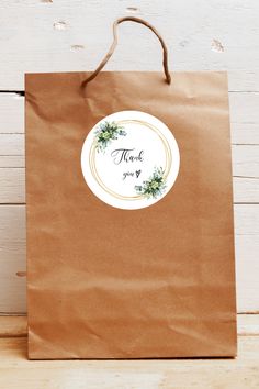 a brown paper bag with a thank you sticker on it