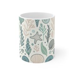 a coffee mug with seaweed, starfish and other marine life printed on it