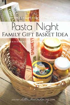 a basket filled with pasta and sauces on top of a wooden table