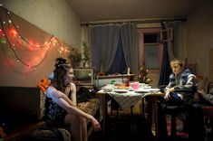 three people sitting at a table in a room