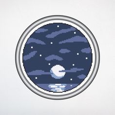 a cross - stitch pattern of an earth with clouds and stars in the sky on a white background