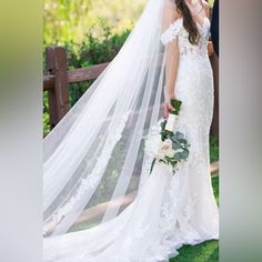 a woman in a wedding dress standing next to a man