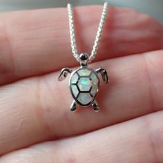 This is a very beautiful turtle necklace. It measures 1/2” long from the top of the jump ring, 1/2" wide and is solid sterling silver with inlaid white lab created opal. The pendant will come on a 1mm rounded box chain. The turtle symbolizes many things. Most of us know the story of the tortoise and the hare, reminding us that slow and steady wins the race. The turtle also symbolizes the earth, staying grounded, wisdom and emotional strength. An interesting fact about turtles is that they have b Nature-inspired Sterling Silver Jewelry With Polished Finish, Nature-inspired Sterling Silver Jewelry, White Sterling Silver Nature-inspired Jewelry, Nature-inspired White Sterling Silver Jewelry, The Tortoise And The Hare, Turtle Facts, Tortoise And The Hare, Staying Grounded, Slow And Steady