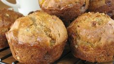 muffins cooling on a wire rack next to a cup