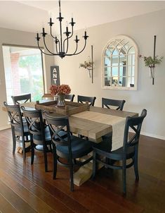 a dining room table with chairs and a chandelier