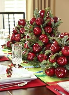 a table topped with lots of red apples