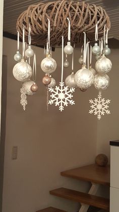 christmas decorations hanging from the ceiling in front of some stairs with snowflakes on them