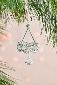 a christmas ornament hanging from a pine tree