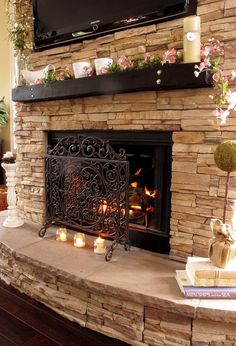 a living room with a fire place and television above the fireplace in front of it