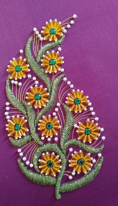 an embroidered piece with flowers and pearls on it