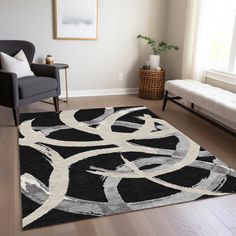 a black and white rug in a living room next to a chair with a plant on it