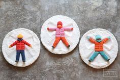 three decorated cookies sitting on top of a table