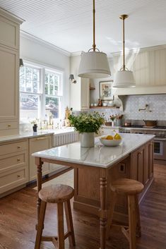 a kitchen with an island and two stools