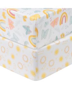 a white box with yellow and blue designs on it's sides, sitting in front of a white background