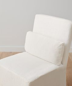 a white chair sitting on top of a hard wood floor