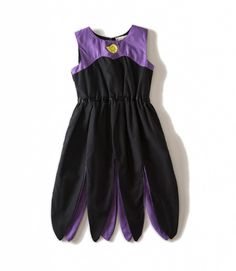 a purple and black dress hanging on the wall