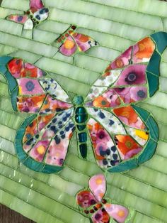 stained glass butterfly on green tile with flowers