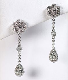 A daisy of diamonds on the post with a single diamond suspended on a chain and a pave diamond teardrop completes these lovely earrings. Beautifully detailed and very feminine earrings for a wedding or just because. Metal: 18k white gold Total weight of the diamonds: .76 carats round brilliant G-H color VS2 Clarity The earrings are 1 1/4 inches total length and 3/8 inches wide at the top Jewelry from Stowe Gems arrives beautifully packaged in a gift box. If you have any questions about this piece Wedding Drop Diamond Earrings With Single Cut Diamonds, Wedding Drop Diamond Earrings With Single Cut, Wedding Dangle Diamond Earrings With Single Cut Diamonds, Wedding Diamond Dangle Earrings With Single Cut Diamonds, Dangle Diamond Earrings With Single Cut Diamonds For Wedding, Dangle Diamond Earrings With Single Cut For Wedding, Formal Diamond Teardrop Dangle Earrings, Drop Diamond Earrings With Pave Setting For Wedding, Wedding Diamond Earrings With Pave Setting