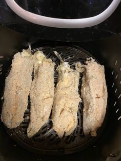 four pieces of meat cooking in an air fryer