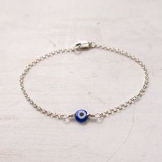 "Dainty Evil Eye Bracelet in Sterling Silver A minimalist take on traditional evil eye protection bracelet. Dainty and lightweight, easy to wear every day. Great on its own or for layering with other bracelets. It will make a wonderful gift for sister, friend, girlfriend. You can pair the cobalt blue bracelet with a matching necklace: https://www.etsy.com/listing/607878204/ MEANING: The evil eye is a curse believed to be cast by a malevolent glare. Many cultures believe that receiving the evil e Cheap Beaded Evil Eye Bracelet For Gifts, Handmade Blue Evil Eye Bracelet In Sterling Silver, Handmade Sterling Silver Blue Evil Eye Bracelet, Handmade Blue Sterling Silver Evil Eye Bracelet, Minimalist Blue Evil Eye Bracelet For Everyday, Evil Eye Bracelet Ideas, Evil Eye Jewelry Bracelet, Evil Eye Bracelet Silver, Nazar Bracelet