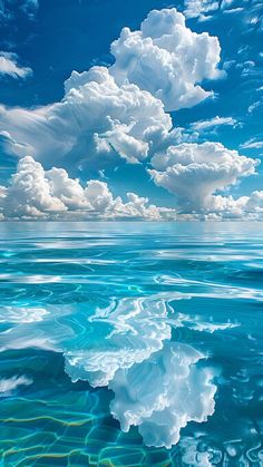 the sky is filled with clouds and blue water, as well as an ocean surface