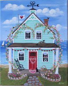 a painting of a blue house with flowers on the front and red door, sitting next to a beach