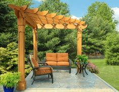 an outdoor seating area with two chairs and a couch under a pergolated roof