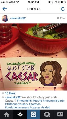 a table topped with a bowl of salad next to a sign that says just star caesar