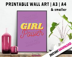 a poster with the words girl power on it next to a vase and potted plant