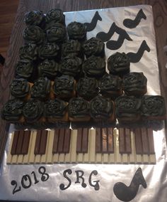 there are many chocolates on the table and one is decorated with music notes as well