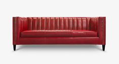 a red leather couch with black legs and studding on the arm, against a white background