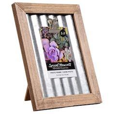 a wooden frame with flowers in it