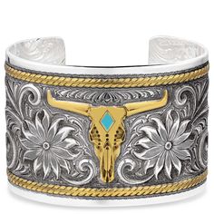 PRICES MAY VARY. Power and beauty come together to create the Meadow Majesty Cuff Bracelet. This cuff bracelet features a stunning steer head design. The steer head is in a gorgeous gold tone with a turquoise diamond in the center. The turquoise adds just a pop of additional color. Silver tone flowers with added antiquing provide striking contrast and a gold tone rope frames the edges of the bracelet. One size fits most. Montana Silversmiths SKU BC1626RTG. Steer Head, Cowboy Stuff, Rope Frame, Head Design, Kids Luggage, Come Together, Womens Jewelry Bracelets, Cuff Bracelet, Montana