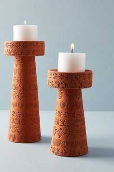 two candles sitting next to each other on a table